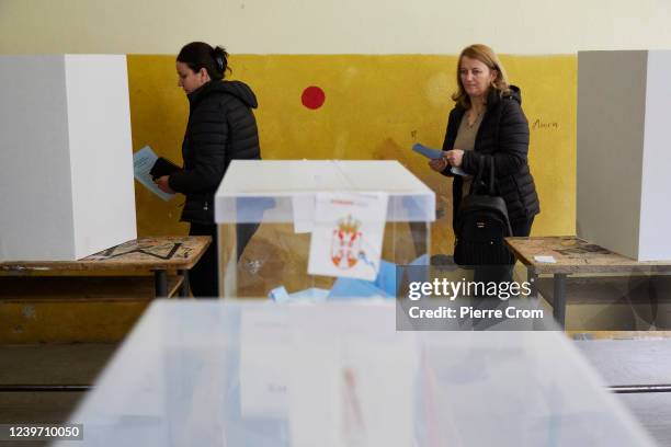 Two women prepare to cast their vote as hundreds of Serbian citizens from neighbouring Kosovo queue up to cast their ballot in a dedicated voting...