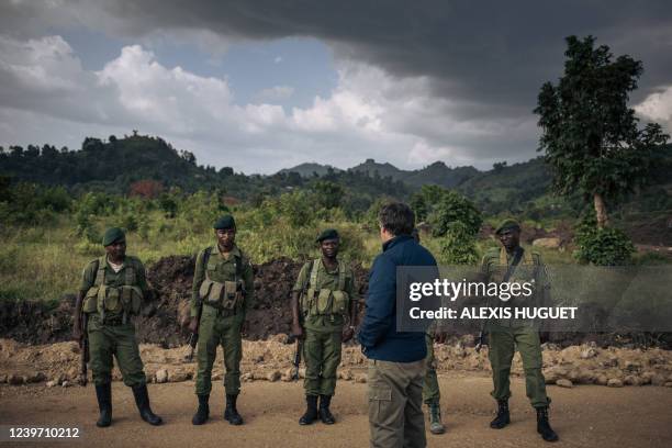 Emmanuel de Merode , director of Virunga National Park, congratulates guards protecting the Matebe hydroelectric plant in Rutshuru territory, north...