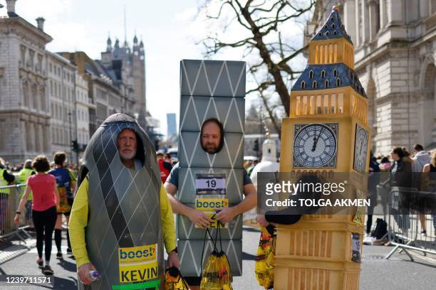 Runners dressed-up as famous London's building speak together after competing in the 2022 London Landmarks Half Marathon, in London, on April 3, 2022.