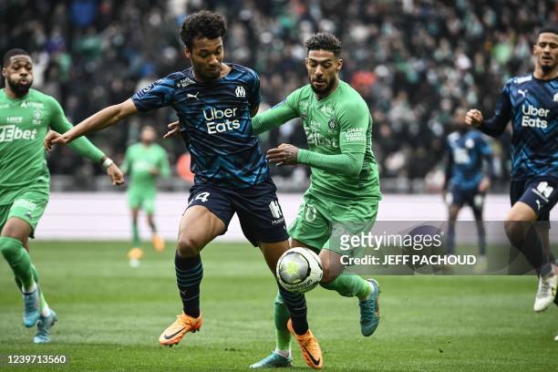 Saint-Etiennes Gabonese forward Denis Bouanga vies for the ball with Marseilles French midfielder Boubacar Kamara during the French L1 football match...