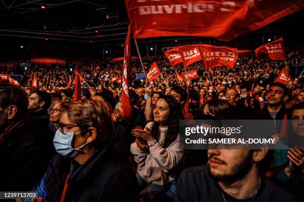 Supporters cheer up during a campaign meeting of French far-left party Lutte Ouvriere presidential candidate Nathalie Arthaud, a week before the...