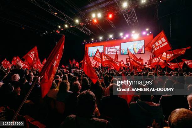 Supporters cheer up during during a campaign meeting of French far-left party Lutte Ouvriere presidential candidate Nathalie Arthaud, a week before...