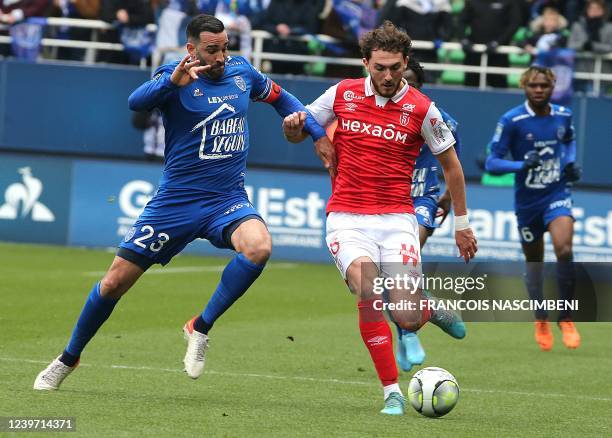Reims' Scottish forward Fraser Hornby fights for the ball with Troyes' French defender Adil Rami during the French Ligue 1 football match between...