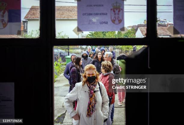 Serbian voters queue to cast their ballot at a polling station during general elections in Belgrade, on April 3, 2022. - Serbians went to the polls...