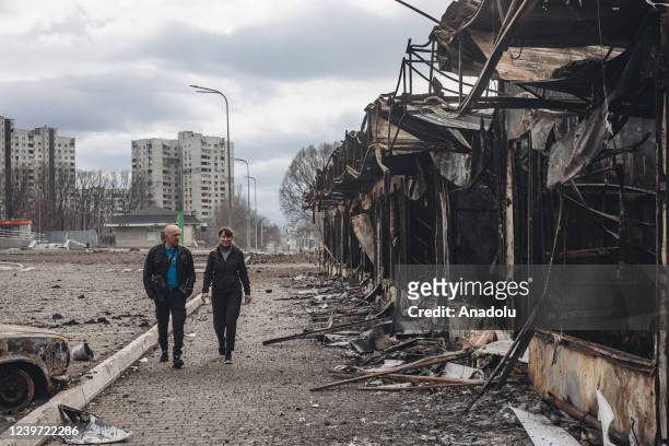 Kharkiv, UKRAINE A couple walks in front of shops destroyed by Russian shelling in Kharkov, Ukraine, 3 April 2022.