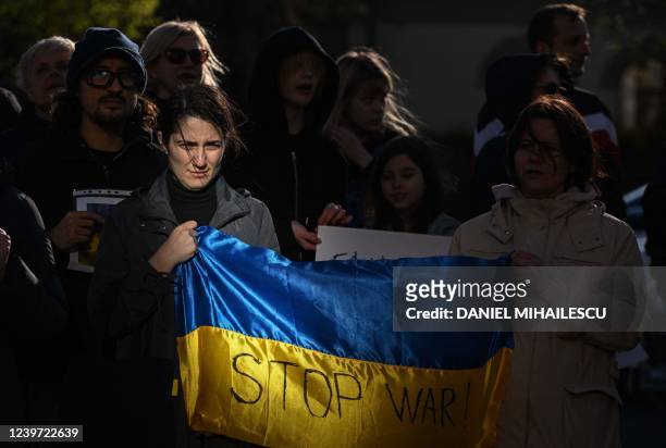 Woman holds a Ukrainian flag with the lettering reading "Stop War!" during a protest against Russia's invasion of Ukraine in the front of the Russian...
