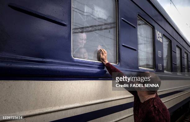 Man says goodbye before the train leaves the eastern city of Kramatorsk, in the Donbas region on April 3, 2022. - AFP journalists saw women, children...