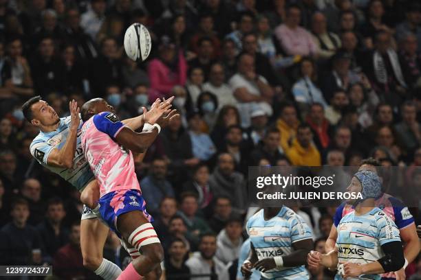 Racing92's French flanker Wenceslas Lauret and Stade Francais' French wing Lester Etien fight for the ball during the French Top14 rugby union match...