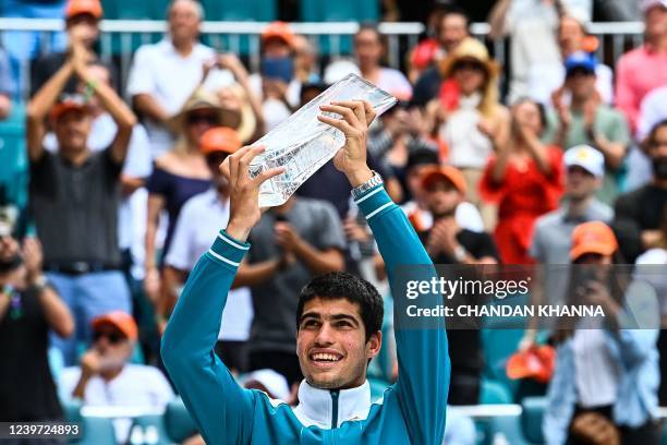 Carlos Alcaraz, of Spain, poses with his trophy after winning the mens single finals at the 2022 Miami Open presented by Ita? at Hard Rock Stadium in...