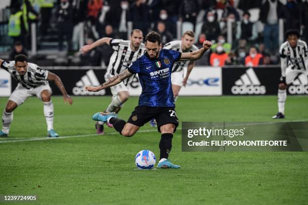 Inter Milan's Turkish midfielder Hakan Calhanoglu shoots to score his second penalty attempt during the Italian Serie A football match between...