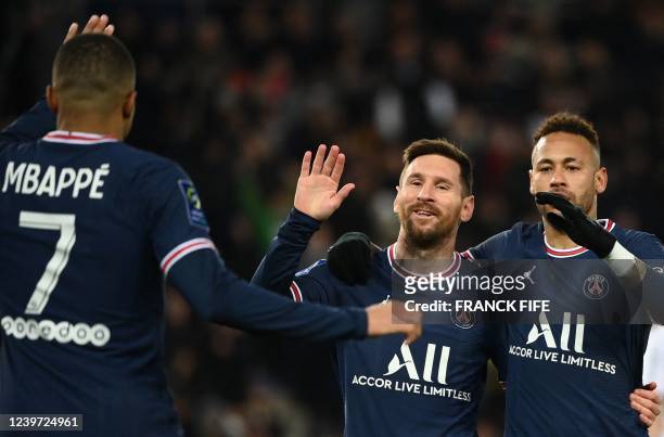 Paris Saint-Germain's Argentinian forward Lionel Messi celebrates with Paris Saint-Germain's Brazilian forward Neymar and Paris Saint-Germain's...
