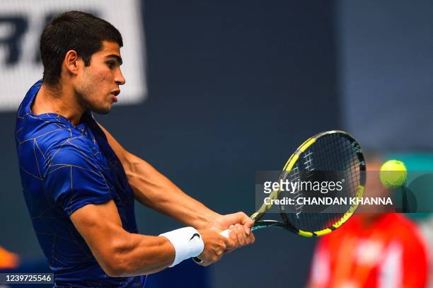 Carlos Alcaraz, of Spain, returns a shot during the mens single finals at the 2022 Miami Open presented by Ita? at Hard Rock Stadium in Miami...