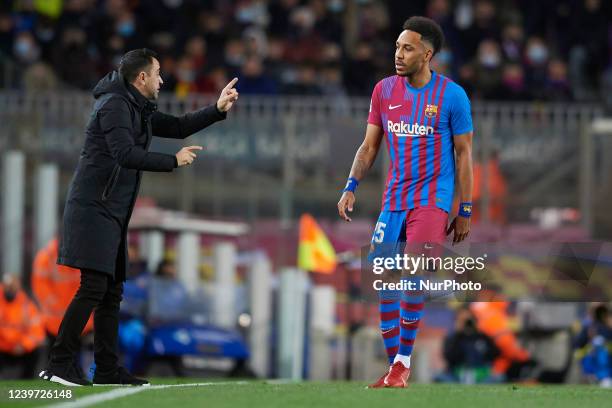 Xavi Hernandez head coach of Barcelona gives instructions to Pierre-Emerick Aubameyang during the La Liga Santander match between FC Barcelona and...