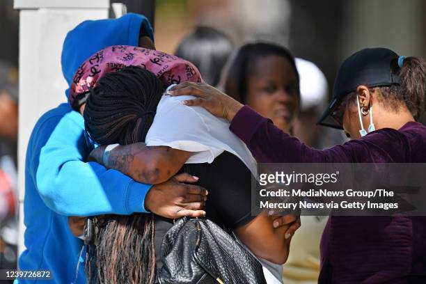 Group of women console each other at the scene of a mass shooting in Sacramento, Calif., on Sunday, April 3, 2022. The family was grieving for a...