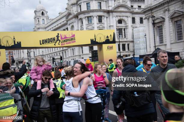 Participants seen hugging after crossing the finish line during the London Landmarks Half Marathon through Westminster and the City. London's central...