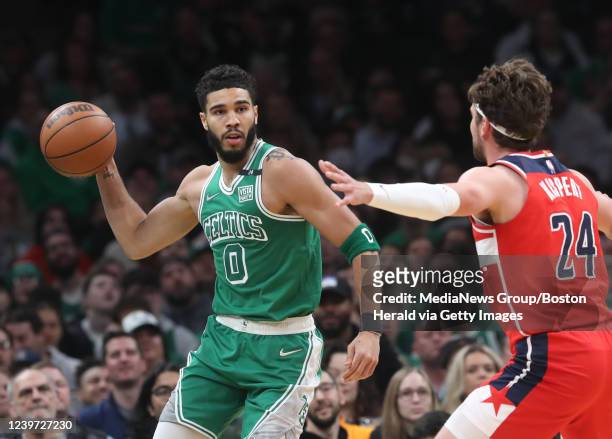 Boston Celtics forward Jayson Tatum gets off a pass around Washington Wizards forward Corey Kispert during the 1st quarter of the game at the TD...