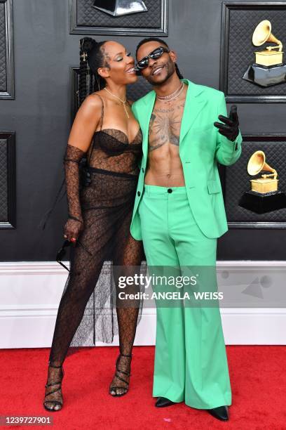 Lamyia Good and US singer-songwriter Eric Bellinger arrive for the 64th Annual Grammy Awards at the MGM Grand Garden Arena in Las Vegas on April 3,...