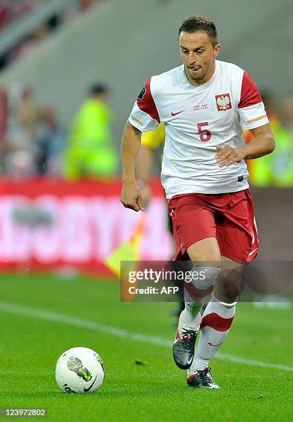 Poland's defender Dariusz Dudka runs with the ball during the International friendly football match Poland vs Germany in the northern Polish city of...