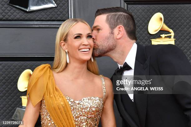 Singer/songwriter Carrie Underwood and husband Mike Fisher arrive for the 64th Annual Grammy Awards at the MGM Grand Garden Arena in Las Vegas on...