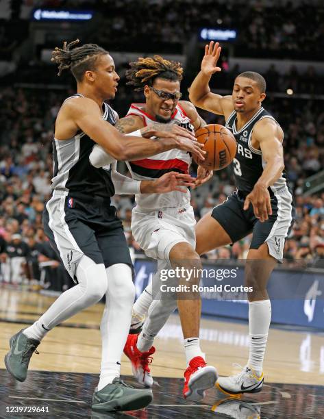 Greg Brown III of the Portland Trailblazers drives against Romeo Landale and Keldon Johnson of the San Antonio Spurs in the first half at AT&T Center...