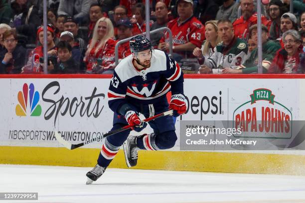 Tom Wilson of the Washington Capitals chases a loose puck during a game against the Minnesota Wild at Capital One Arena on April 3, 2022 in...