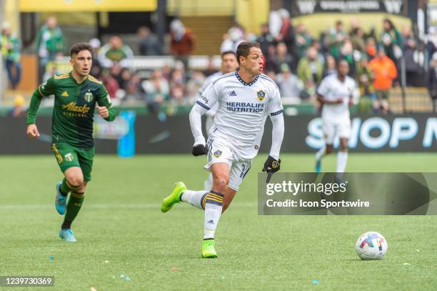 Galaxy forward Javier Hernández "Chicharrito" drives a counter attack chased by Portland Timbers defender Claudio Bravo during the MLS match between...