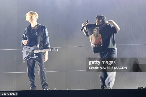 Singer/songwriter Billie Eilish shows her tshirt with a photo of late Foo Fighters drummer Taylor Hawkins as she and US singer-songwriter Finneas...