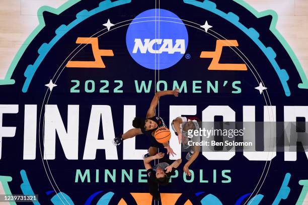 Olivia Nelson-Ododa of the UConn Huskies and Victaria Saxton of the South Carolina Gamecocks compete for the opening tip-off during the championship...