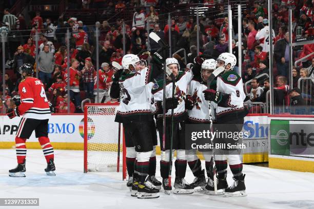 The Arizona Coyotes celebrate after scoring in overtime to defeat the Chicago Blackhawks at United Center on April 03, 2022 in Chicago, Illinois.