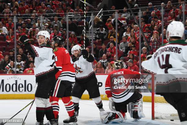 Barrett Hayton and Phil Kessel of the Arizona Coyotes react after the Coyotes scored in overtime to defeat the Chicago Blackhawks at United Center on...