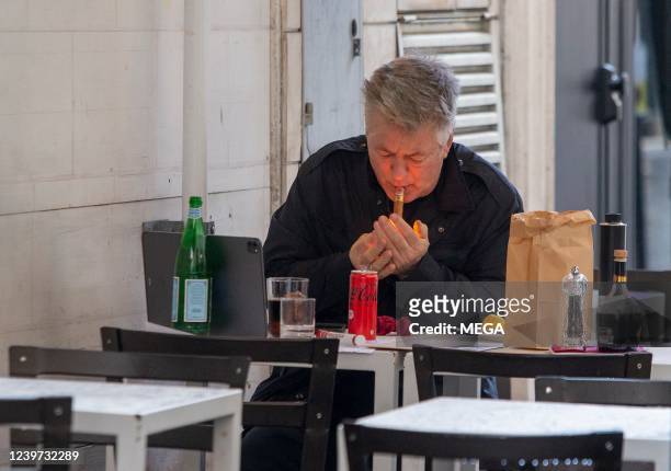 Alec Baldwin is seen at a cafe smoking a cigar on April 3, 2022 in Rome, Italy.