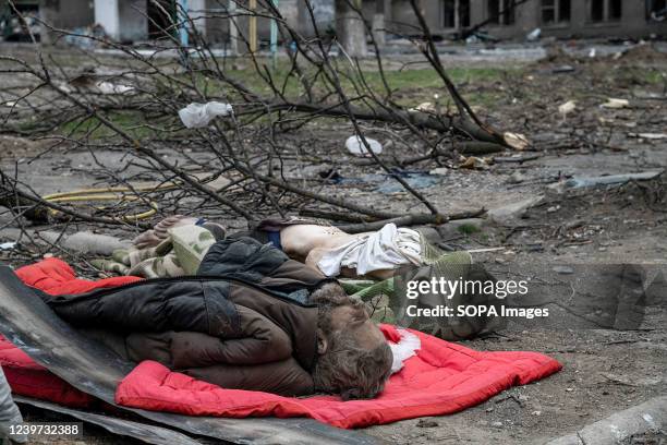 Bodies of dead civilians lie in a bombed out neighbourhood, possibly killed by tank shrapnel seen laying on the street. The battle between Russian /...