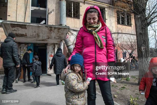 Mother and daughter stand outside their destroyed home. The battle between Russian / Pro Russian forces and the defending Ukrainian forces led by the...