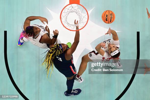 Aaliyah Edwards of the Connecticut Huskies, Aliyah Boston and Victaria Saxton of the South Carolina Gamecocks fight for a rebound during the...