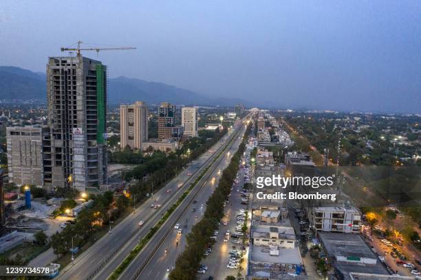 Traffic flows down a road past buildings and construction in Islamabad, Pakistan, on Saturday, April 2, 2022. Pakistan Prime Minister Imran Khan said...