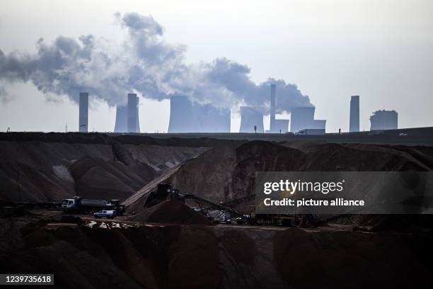 April 2022, North Rhine-Westphalia, Jackerath: Mining machines work in the Garzweiler open pit lignite mine, with the Neurath lignite-fired power...