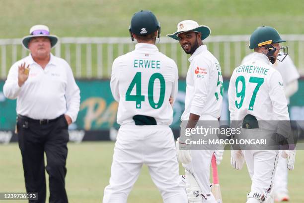 Bangladesh's Ebadot Hossain banters with South Africa's Sarel Erwee during the fifth day of the first Test cricket match between South Africa and...