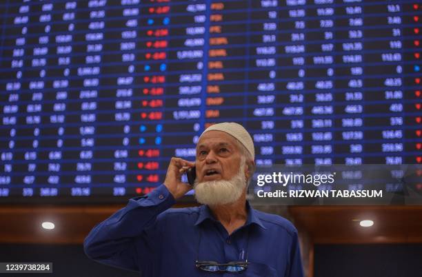 Stockbroker speaks on the phone during a trading session at the Pakistan Stock Exchange in Karachi on April 4, 2022.