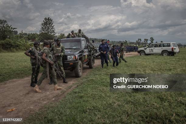 Units of the Armed Force of the Democratic Republic of Congo and police stand at Kiwanja airfield before the departure of the deputy commissioner...