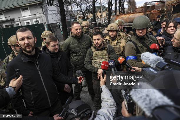 Ukrainian President Volodymyr Zelenskyy accompanied by Ukrainian soldiers speaks to press during his visit at the town of Bucha, after it was...
