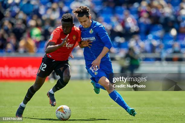 Enes Unal of Getafe and Iddrisu Baba of Mallorca compete for the ball during the La Liga Santander match between Getafe CF and RCD Mallorca at...