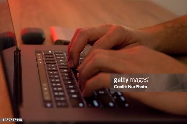 Man's hands are writting on a Macintosh laptop in Athens, Greece on April 4, 2022.