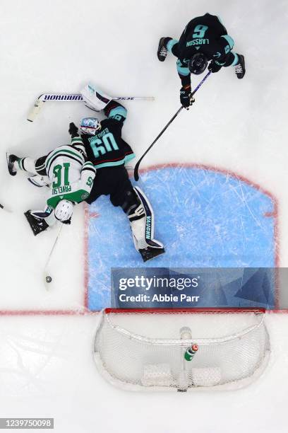 Chris Driedger of the Seattle Kraken defends against Joe Pavelski of the Dallas Stars during the third period at Climate Pledge Arena on April 03,...