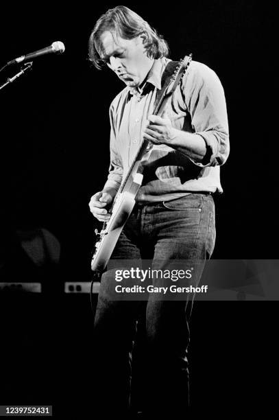 English Rock musician David Gilmour plays guitar as he performs onstage at the Capitol Theatre, Passaic, New Jersey, November 3, 1984. He played...