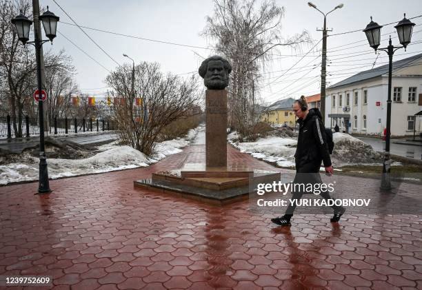 Pedestrian walks past the Karl Marx monument in Tolyatti, also known as Togliatti, on April 1, 2022. - For generations the Russian city of Tolyatti...