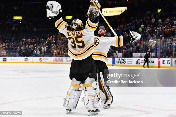 Linus Ullmark and Jeremy Swayman of the Boston Bruins celebrate a 3-2 win over the Columbus Blue Jackets in overtime at Nationwide Arena on April 4,...