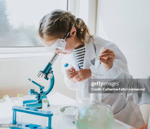 female child scientist with microscope - 科学者　子供 ストックフォトと画像