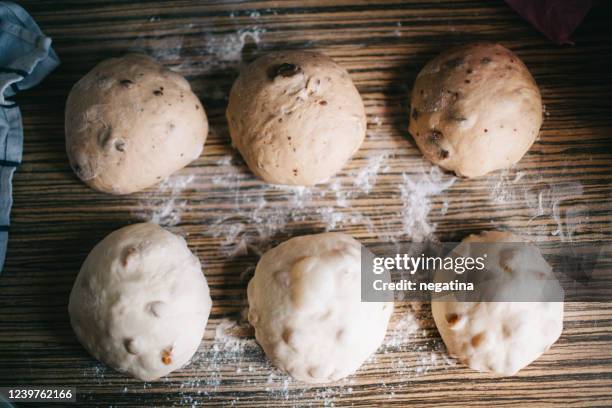 six round raw balls of the sweet dough on the table - panettone stock pictures, royalty-free photos & images