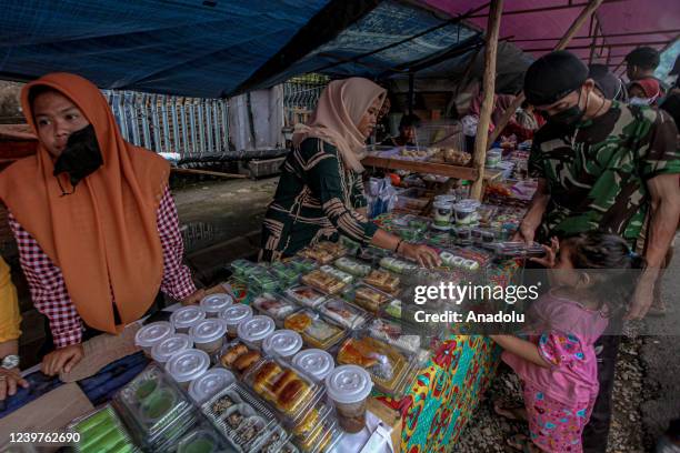 Indonesian Muslims buy food for breaking the fast at a Ramadan market known as Pasar Bedug in Palembang, Indonesia on April 04, 2022. Pasar Bedug is...