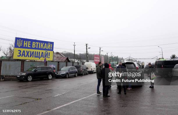 Ukrainians forced to leave Ukraine because of the Russian invasion stand in line at the Ukrainian-Polish checkpoint "Shehyni" , western Ukraine